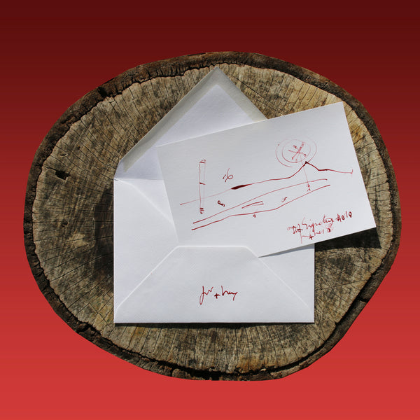 On the log : In the foreground the JA.SIGNATURE N°10 paper card - below the the back side of the James Arax Signature.