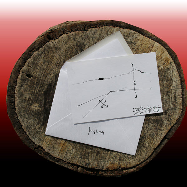 On the log : In the foreground the JA.Signature N°2 paper card - below the the back side of the James Arax Signature