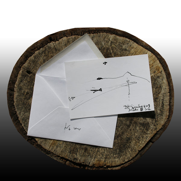 On the log : In the foreground the JA.SIGNATURE N°5  paper card - below the the back side of the James Arax Signature.