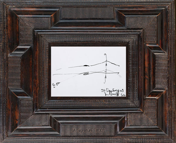 The paper card JA.SIGNATURE N°3 by james arax staged in an ancient frame.