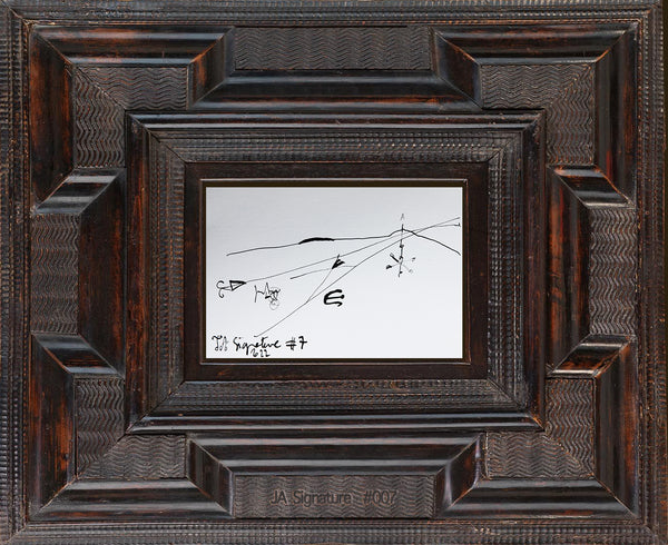 The paper card JA.SIGNATURE N°7 by james arax staged in an ancient frame.